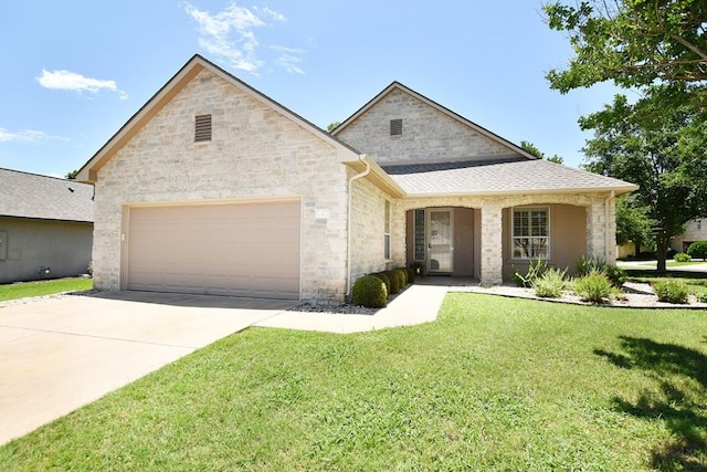 101 Bass St, Georgetown, TX 78633 - view of front of property with an attached garage, stone siding, a front lawn, and concrete driveway