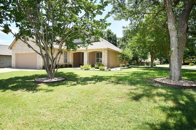101 Bass St, Georgetown, TX 78633 - view of front of house with stone siding, a front lawn, driveway, and an attached garage