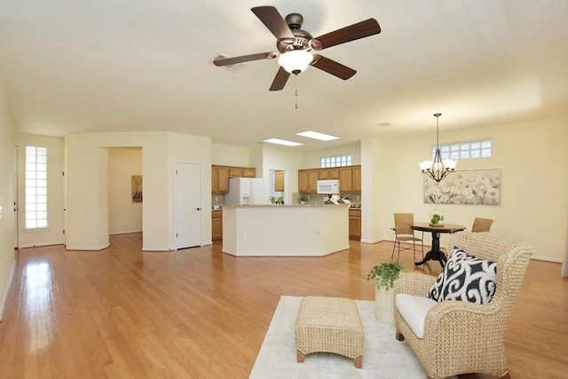 101 Bass St, Georgetown, TX 78633 - living room with a ceiling fan, light wood finished floors, healthy amount of natural light, and a chandelier