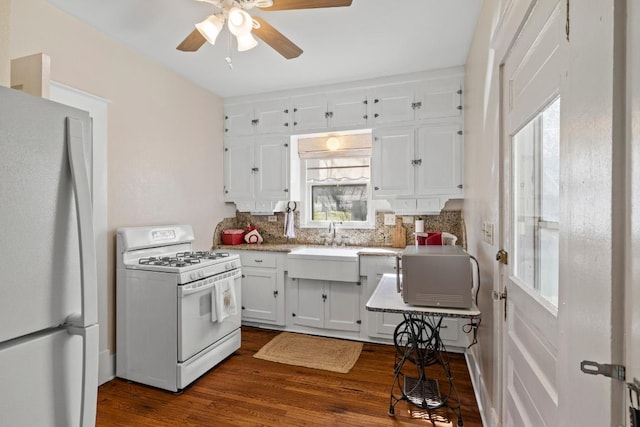 306 S Market St, Flatonia, TX 78941 - kitchen with white appliances, decorative backsplash, ceiling fan, white cabinets, and plenty of natural light
