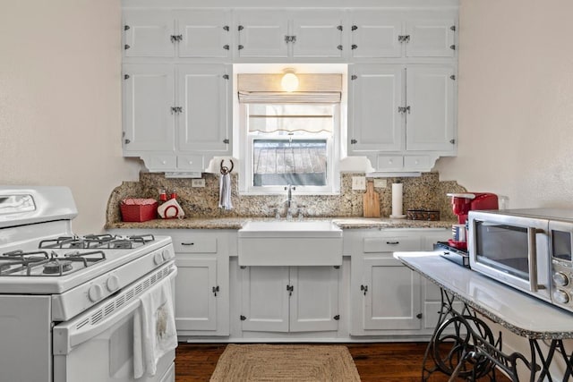 306 S Market St, Flatonia, TX 78941 - kitchen featuring gas range gas stove, white cabinetry, and tasteful backsplash