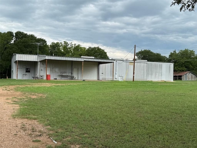 291 Reids Bnd, Bastrop, TX 78602 - view of pole building with a lawn