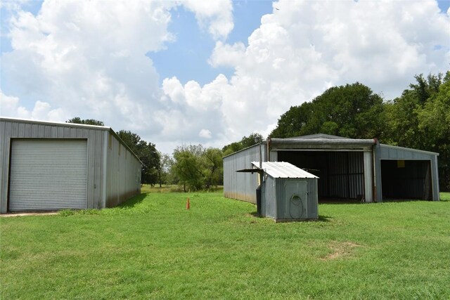 291 Reids Bnd, Bastrop, TX 78602 - view of grassy yard with a pole building, an outbuilding, and a detached garage