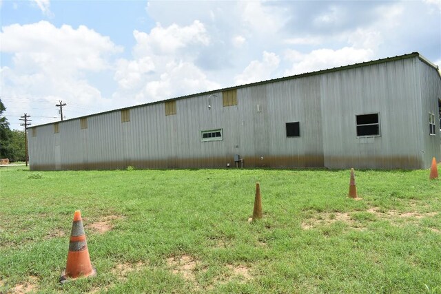 291 Reids Bnd, Bastrop, TX 78602 - view of property exterior with a pole building, a lawn, and an outbuilding