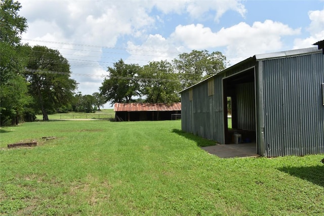 291 Reids Bnd, Bastrop, TX 78602 - view of grassy yard featuring a pole building and an outdoor structure