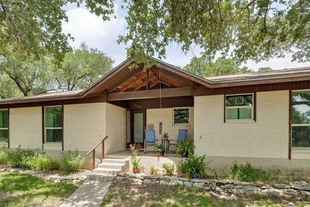 8604 Granada Hills Dr, Austin, TX 78737 - view of front of property featuring brick siding and a porch