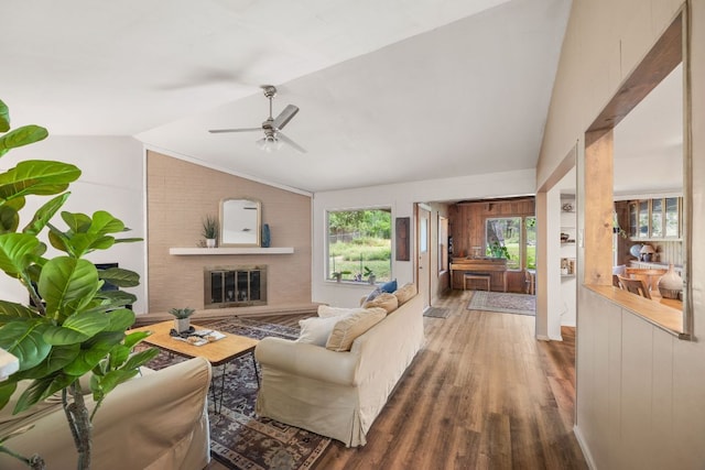 8604 Granada Hills Dr, Austin, TX 78737 - living area featuring a ceiling fan, vaulted ceiling, wood finished floors, and a fireplace