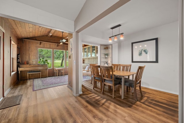 8604 Granada Hills Dr, Austin, TX 78737 - dining area with light wood-style flooring, vaulted ceiling, ceiling fan, wood walls, and wood ceiling