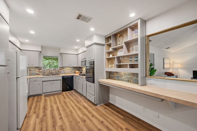 8604 Granada Hills Dr, Austin, TX 78737 - kitchen with black appliances, gray cabinets, light countertops, backsplash, and light wood-type flooring