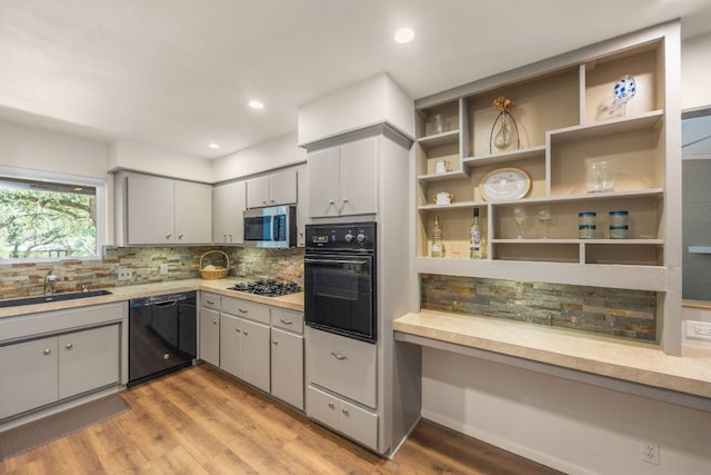 8604 Granada Hills Dr, Austin, TX 78737 - kitchen featuring black appliances, light countertops, tasteful backsplash, light wood finished floors, and recessed lighting