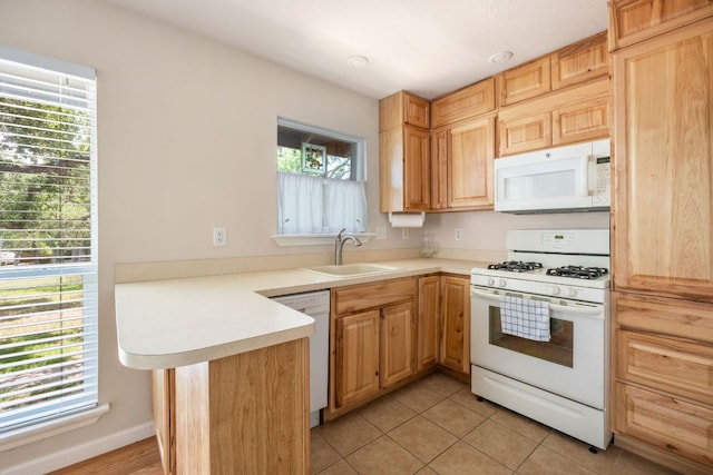 8604 Granada Hills Dr, Austin, TX 78737 - kitchen with white appliances, a peninsula, light countertops, light tile patterned floors, and light brown cabinets