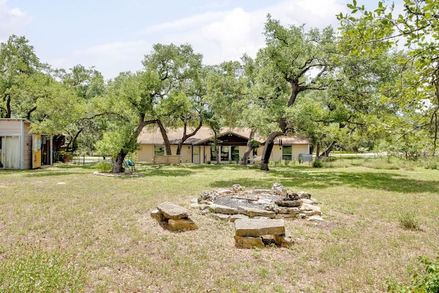 8604 Granada Hills Dr, Austin, TX 78737 - view of green lawn with a storage unit and a fire pit