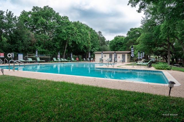 8604 Granada Hills Dr, Austin, TX 78737 - community pool with a lawn, a patio area, and view of scattered trees