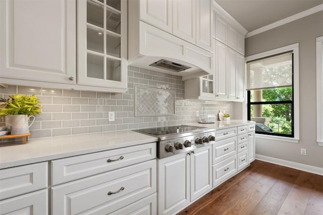 27 Autumn Oaks Dr, The Hills, TX 78738 - kitchen featuring stainless steel gas stovetop, glass insert cabinets, dark wood-type flooring, crown molding, and light countertops