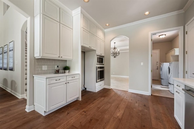 27 Autumn Oaks Dr, The Hills, TX 78738 - kitchen with stainless steel appliances, arched walkways, separate washer and dryer, light countertops, and recessed lighting