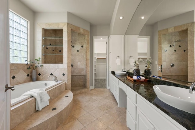 27 Autumn Oaks Dr, The Hills, TX 78738 - bathroom featuring a garden tub, a tile shower, double vanity, plenty of natural light, and recessed lighting