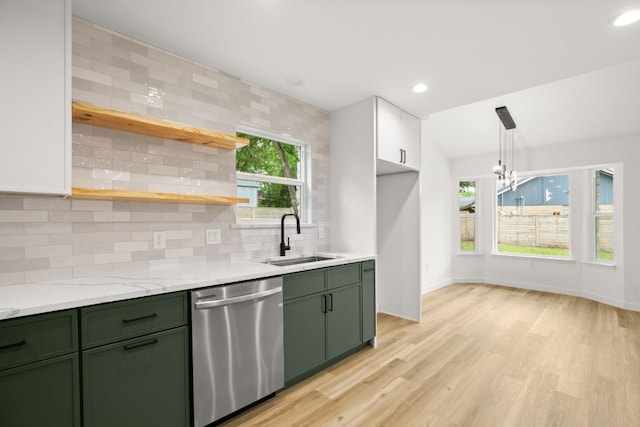 11615 February Dr, Austin, TX 78753 - kitchen featuring green cabinets, stainless steel dishwasher, light wood-style flooring, a chandelier, and backsplash