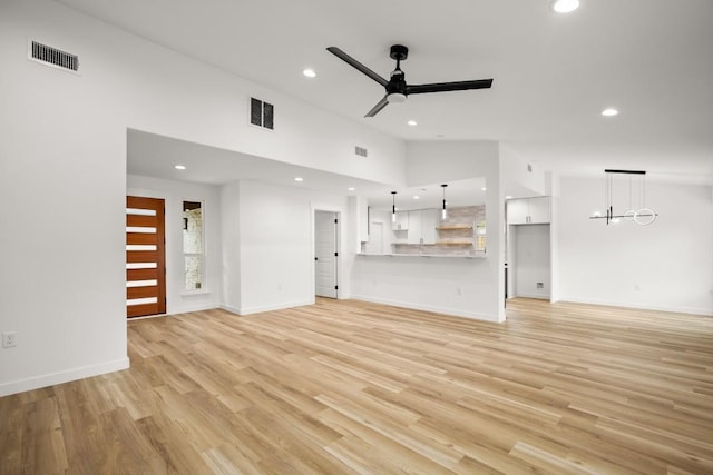 11615 February Dr, Austin, TX 78753 - unfurnished living room with ceiling fan, recessed lighting, light wood-style floors, and lofted ceiling