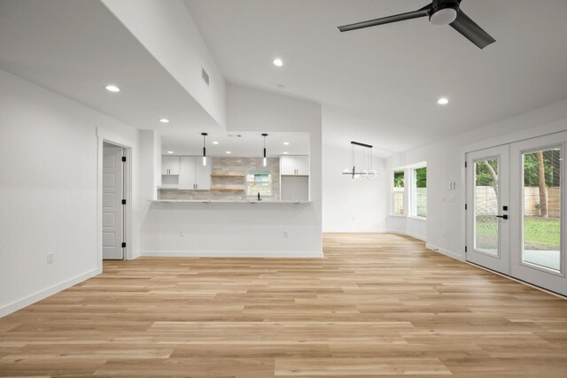 11615 February Dr, Austin, TX 78753 - unfurnished living room featuring french doors, plenty of natural light, a ceiling fan, lofted ceiling, and light wood finished floors