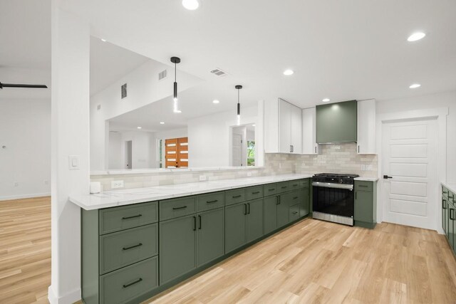 11615 February Dr, Austin, TX 78753 - kitchen featuring green cabinets, gas stove, custom exhaust hood, backsplash, and light wood-style flooring