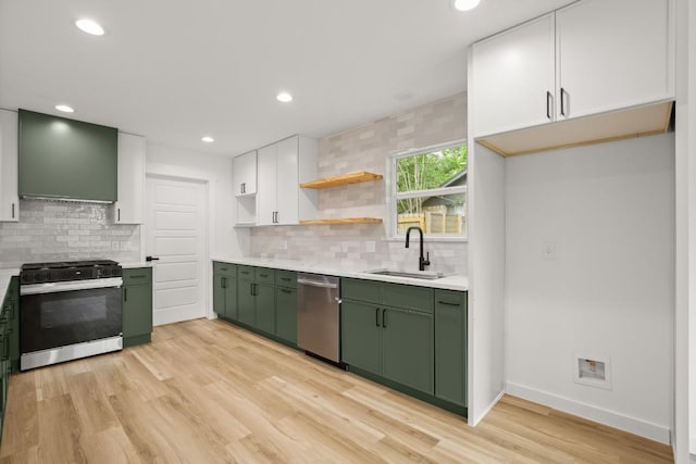 11615 February Dr, Austin, TX 78753 - kitchen with green cabinetry, range with gas cooktop, stainless steel dishwasher, wall chimney exhaust hood, and recessed lighting