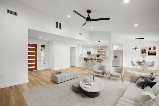 11615 February Dr, Austin, TX 78753 - living room with light wood-style flooring, a ceiling fan, recessed lighting, and vaulted ceiling