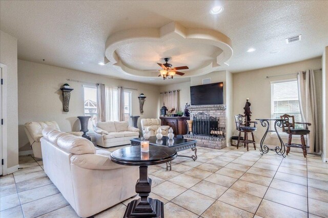 913 Overcup Dr, San Marcos, TX 78666 - living area with a textured ceiling, light tile patterned flooring, a brick fireplace, ceiling fan, and recessed lighting