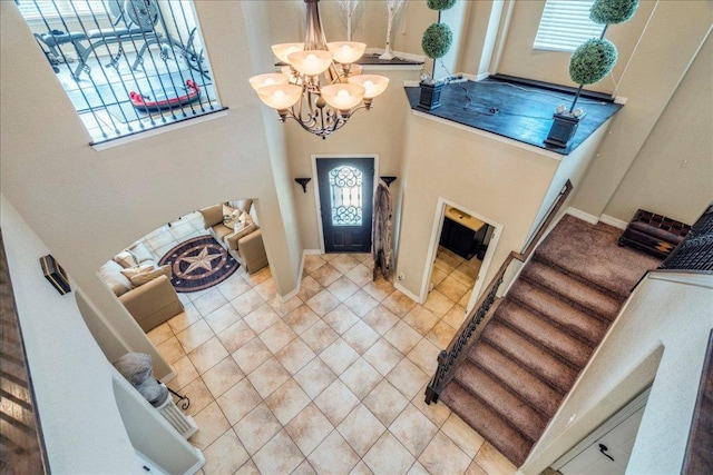 913 Overcup Dr, San Marcos, TX 78666 - tiled foyer entrance with a chandelier, a high ceiling, and stairs