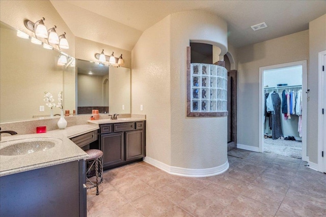 913 Overcup Dr, San Marcos, TX 78666 - full bathroom featuring vanity, a walk in shower, a walk in closet, and tile patterned floors