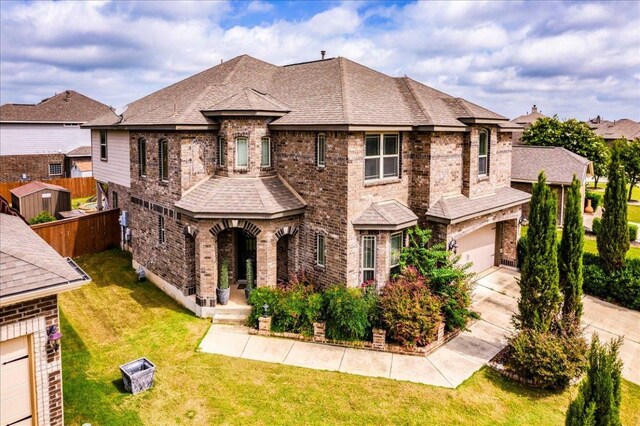 913 Overcup Dr, San Marcos, TX 78666 - french country inspired facade featuring brick siding, an attached garage, concrete driveway, and roof with shingles