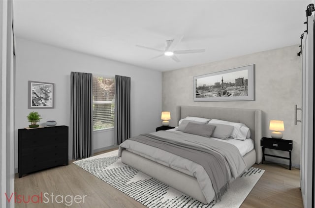 4712 Carsonhill Dr, Austin, TX 78723 - bedroom featuring wood finished floors, ceiling fan, and a barn door