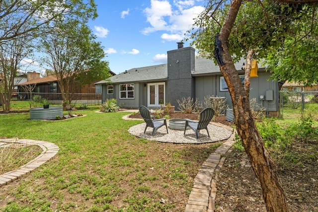 4712 Carsonhill Dr, Austin, TX 78723 - rear view of property featuring french doors, a chimney, a patio area, and board and batten siding