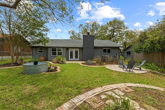 4712 Carsonhill Dr, Austin, TX 78723 - back of house featuring french doors, a chimney, a fire pit, and a patio area