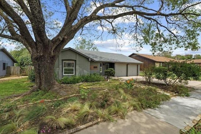 4712 Carsonhill Dr, Austin, TX 78723 - view of front of house with an attached garage, driveway, and brick siding