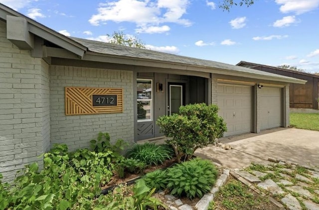 4712 Carsonhill Dr, Austin, TX 78723 - view of front of home featuring driveway, brick siding, and an attached garage