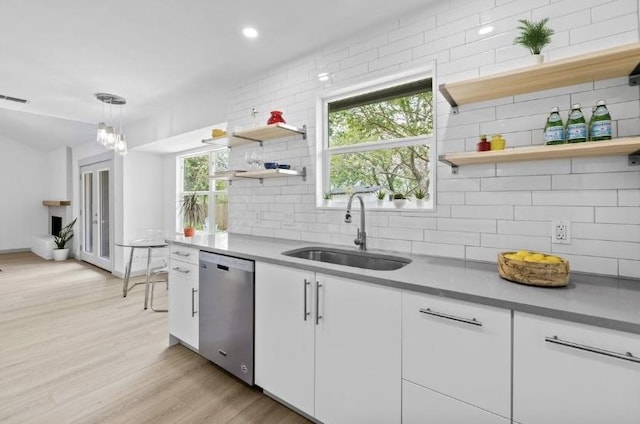 4712 Carsonhill Dr, Austin, TX 78723 - kitchen with dishwasher, open shelves, backsplash, white cabinetry, and light wood finished floors