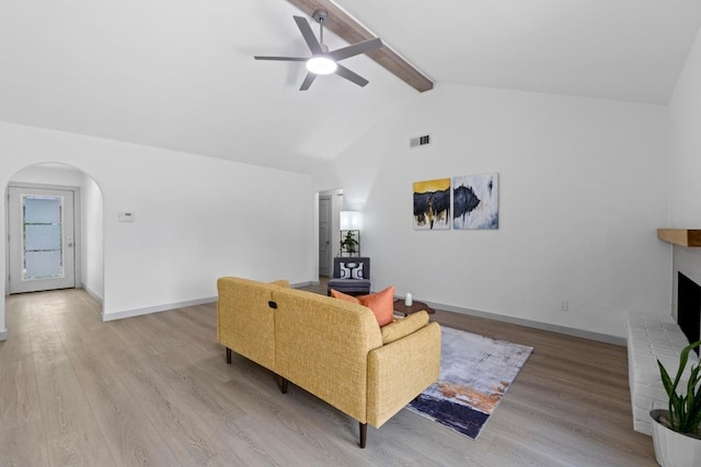 4712 Carsonhill Dr, Austin, TX 78723 - living area featuring a ceiling fan, arched walkways, wood finished floors, and a fireplace