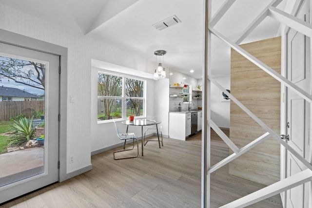 4712 Carsonhill Dr, Austin, TX 78723 - doorway to outside featuring light wood-type flooring and a chandelier
