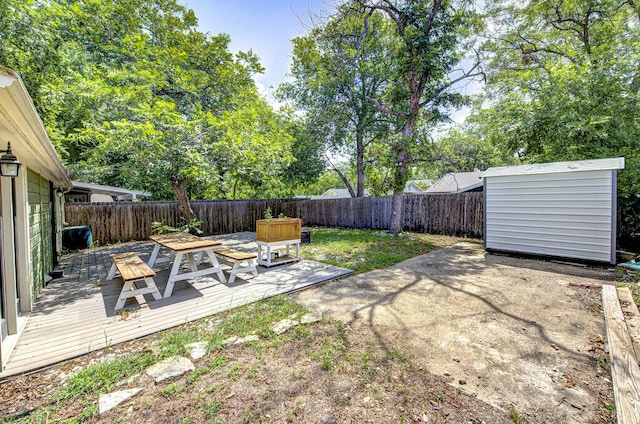 3303 Hollywood Ave, Austin, TX 78722 - fenced backyard featuring a deck, a storage shed, and a patio area