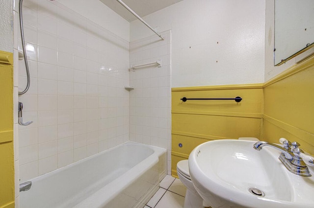 3303 Hollywood Ave, Austin, TX 78722 - bathroom featuring tub / shower combination, a wainscoted wall, and tile patterned floors