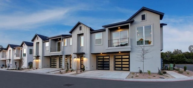 12001 Vista Parke Dr Unit 1002, Austin, TX 78726 - contemporary home with driveway, a garage, board and batten siding, and a balcony