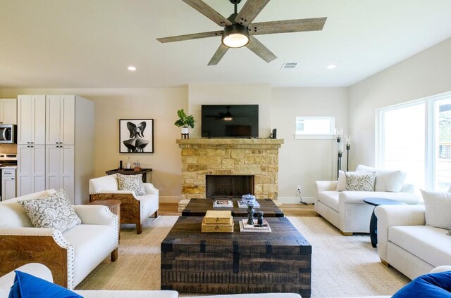 302 Castlehigh Dr, Granite Shoals, TX 78654 - living room featuring ceiling fan, recessed lighting, a stone fireplace, and light wood finished floors
