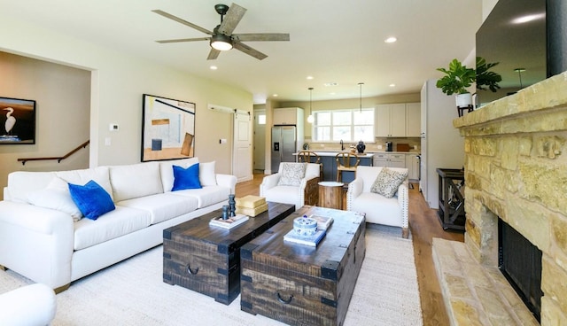 302 Castlehigh Dr, Granite Shoals, TX 78654 - living area with light wood-type flooring, ceiling fan, recessed lighting, and a stone fireplace