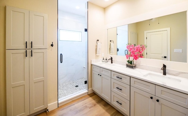 302 Castlehigh Dr, Granite Shoals, TX 78654 - full bath with double vanity, a stall shower, wood finished floors, and recessed lighting