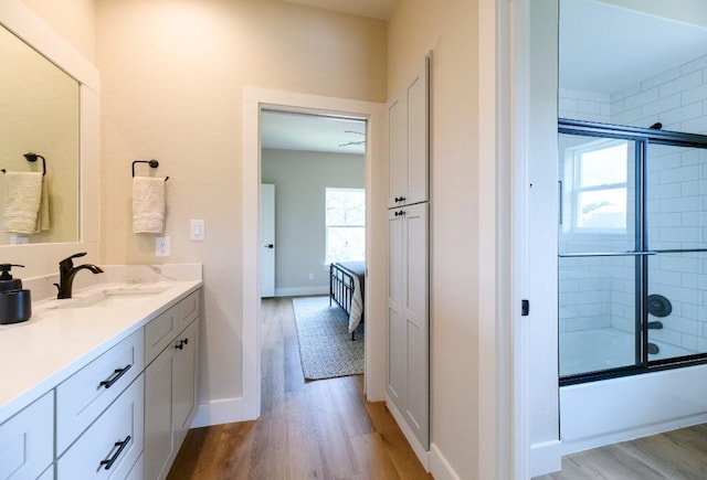 302 Castlehigh Dr, Granite Shoals, TX 78654 - ensuite bathroom featuring vanity, wood finished floors, and shower / bath combination with glass door