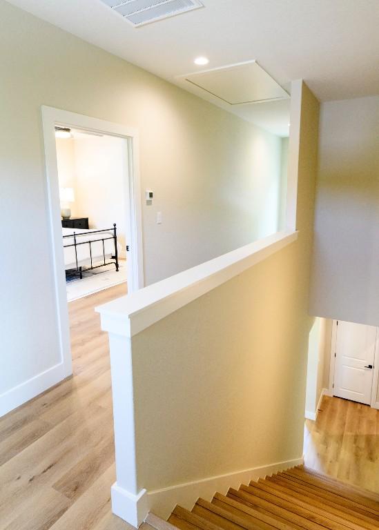 302 Castlehigh Dr, Granite Shoals, TX 78654 - stairway with wood finished floors and attic access