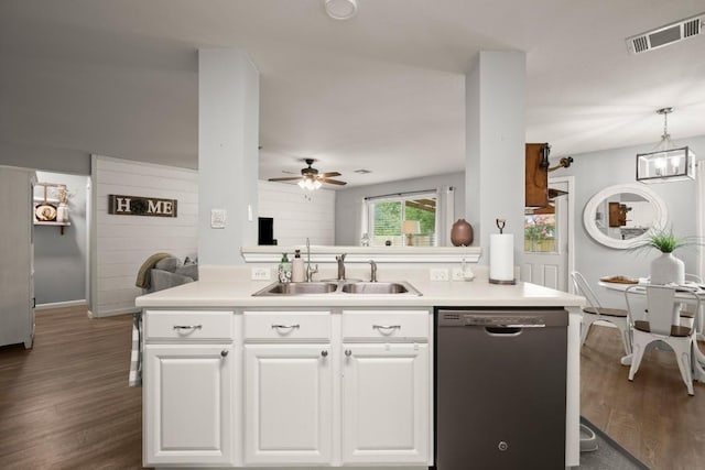 124 Phillips St, Hutto, TX 78634 - kitchen with stainless steel dishwasher, a ceiling fan, dark wood-style flooring, and light countertops