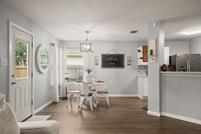 124 Phillips St, Hutto, TX 78634 - dining space with dark wood-style flooring and a chandelier