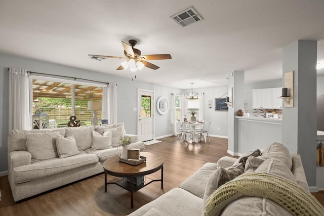 124 Phillips St, Hutto, TX 78634 - living area with ceiling fan, plenty of natural light, wood finished floors, and a chandelier