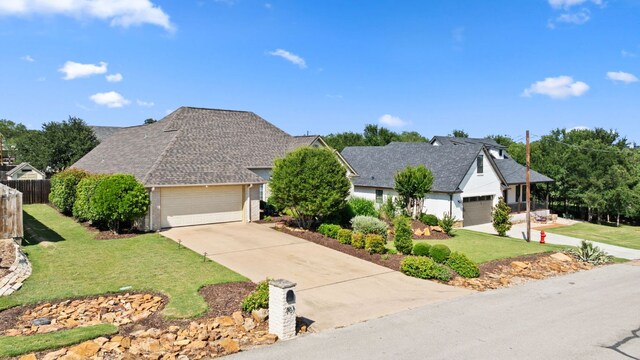 703 Amy Cir, Marble Falls, TX 78654 - view of front of home featuring concrete driveway, a garage, and a shingled roof